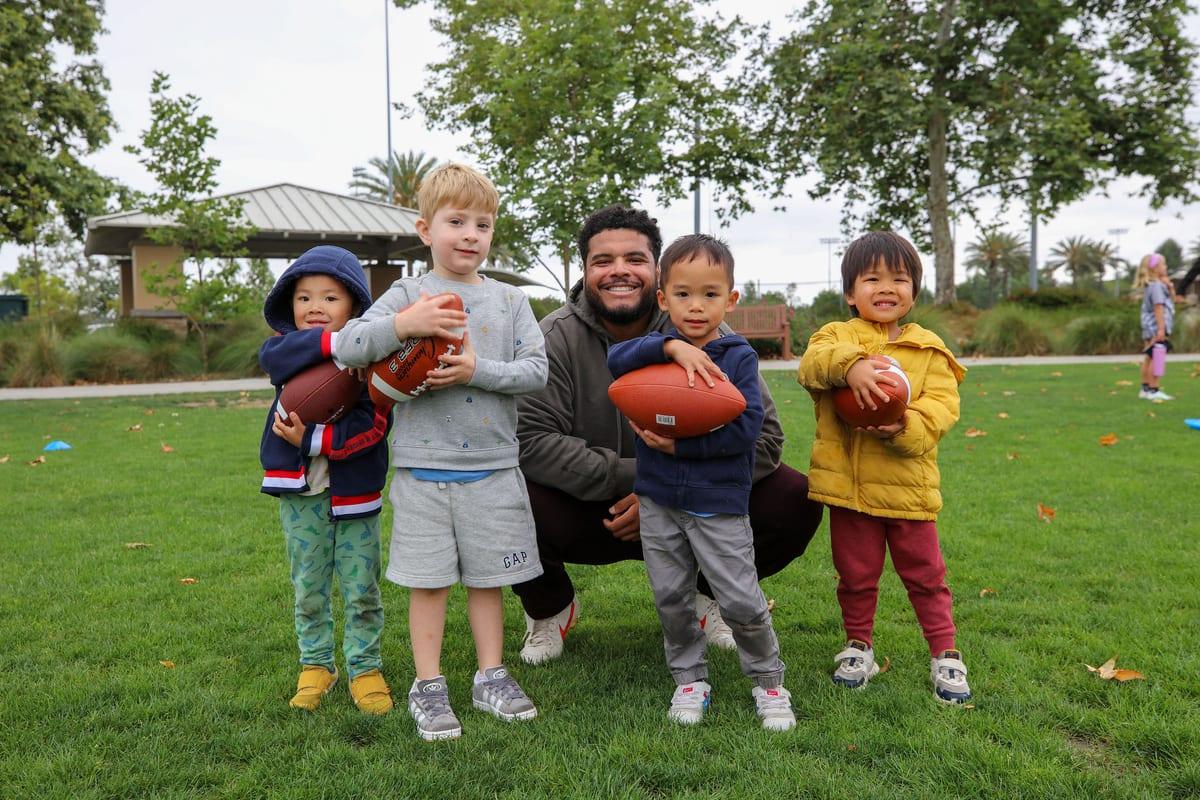 AFC coach Mike laughing with young athletes during a Foundations session