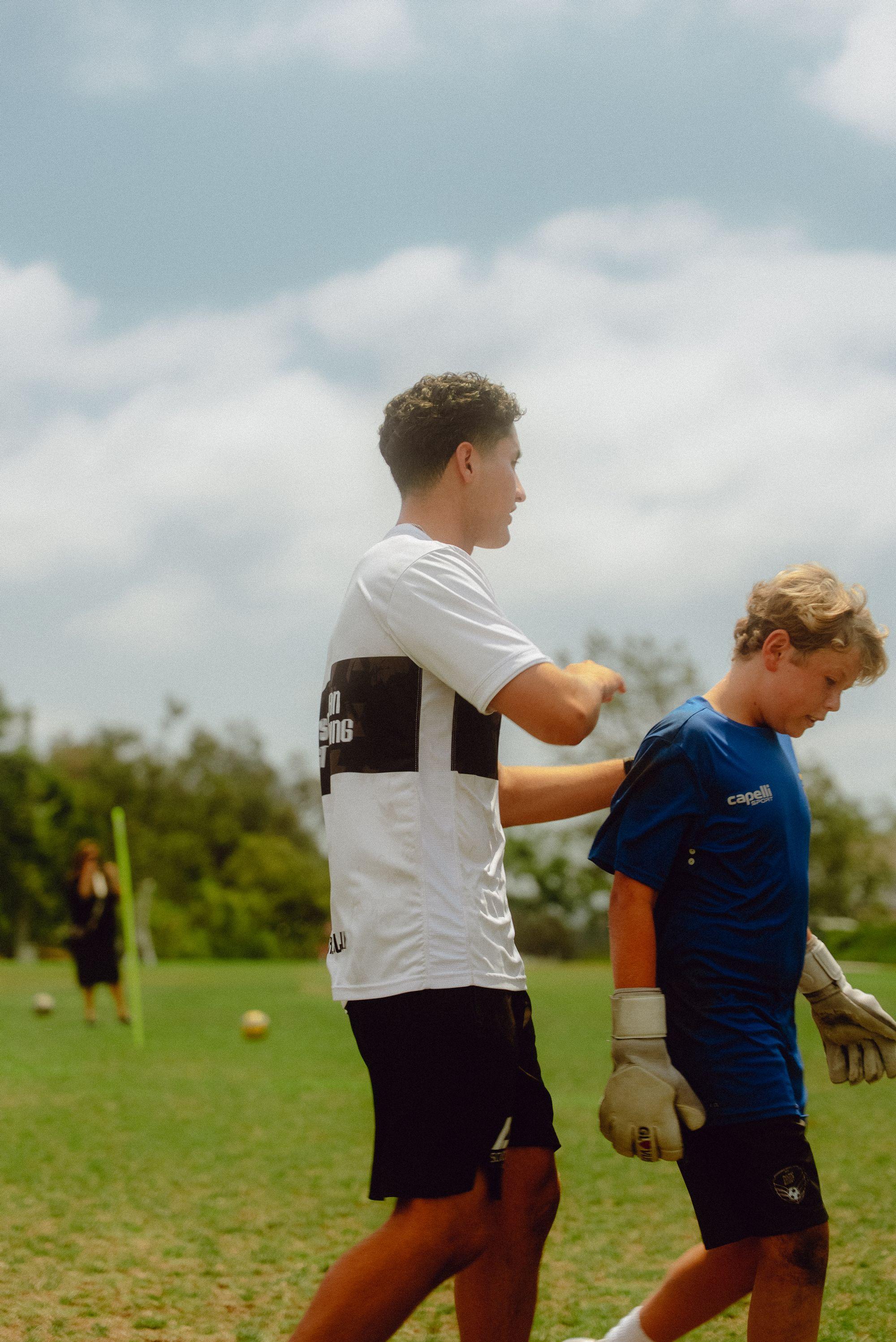 AFC founder Andre Flores coaching a young goalkeeper one-on-one on the field