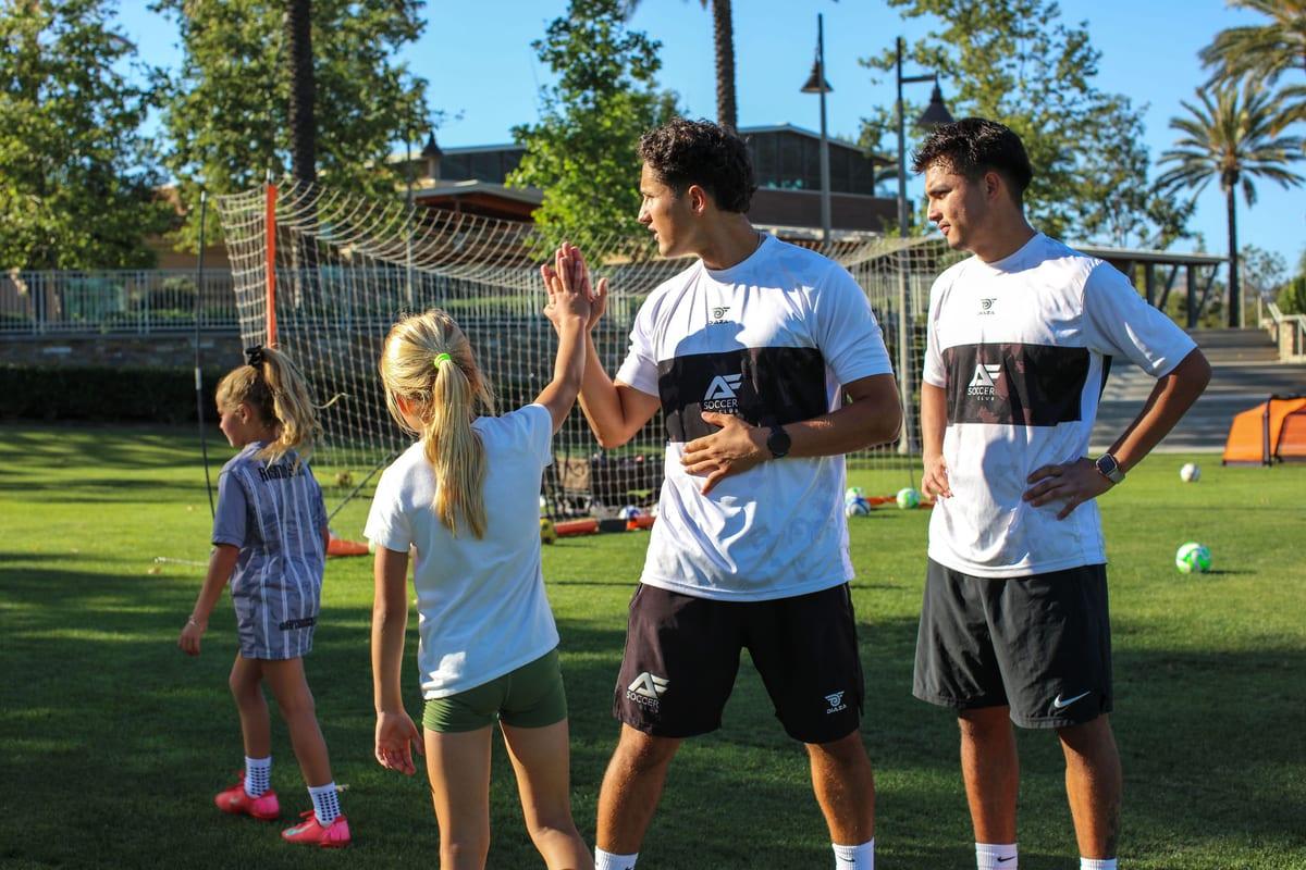 AFC coaches high-fiving young athletes after a drill in Lake Forest